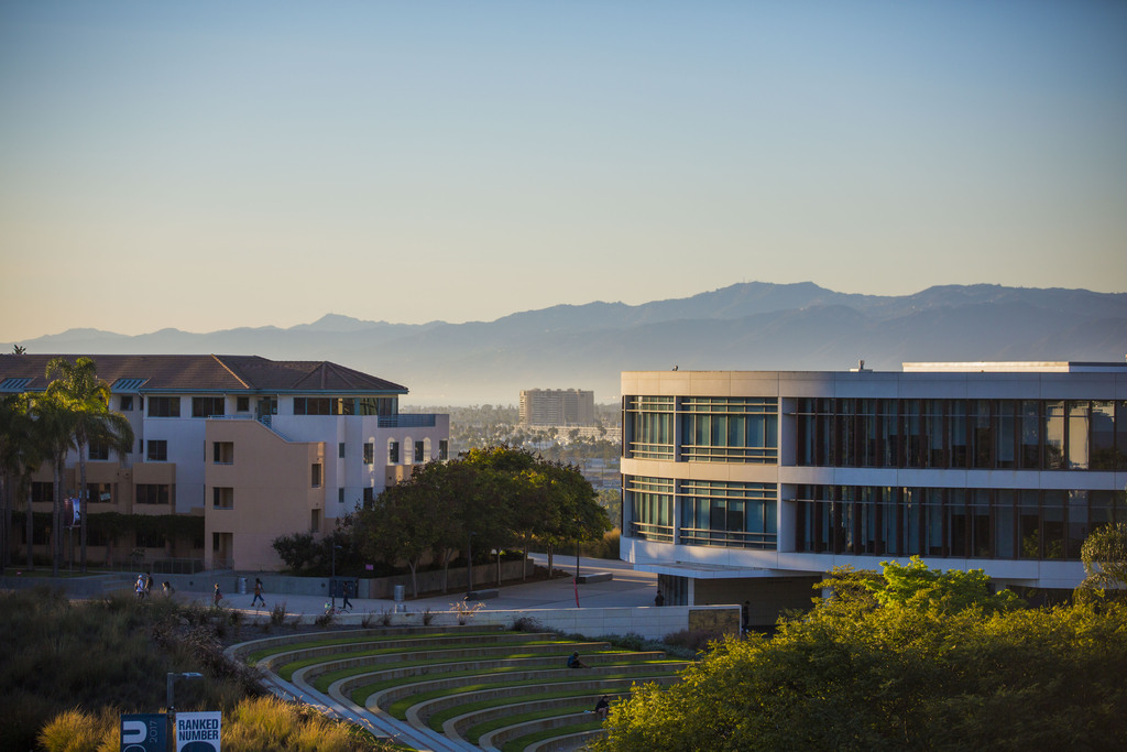 Drone shot of LMU's library with mountains in the background taken at sundown.